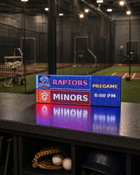 FieldFire Standard three-panel LED matrix scoreboard at an indoor baseball training facility.
